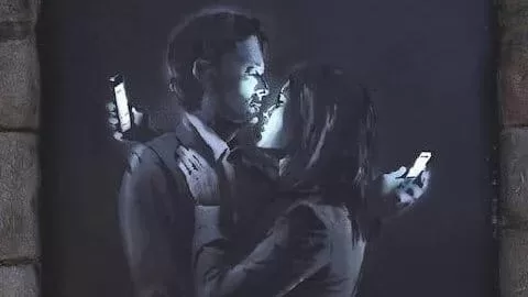 Banksy art couple using smartphones and ignoring each other
