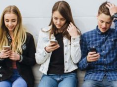 Image of teenage children fixated with their smartphones
